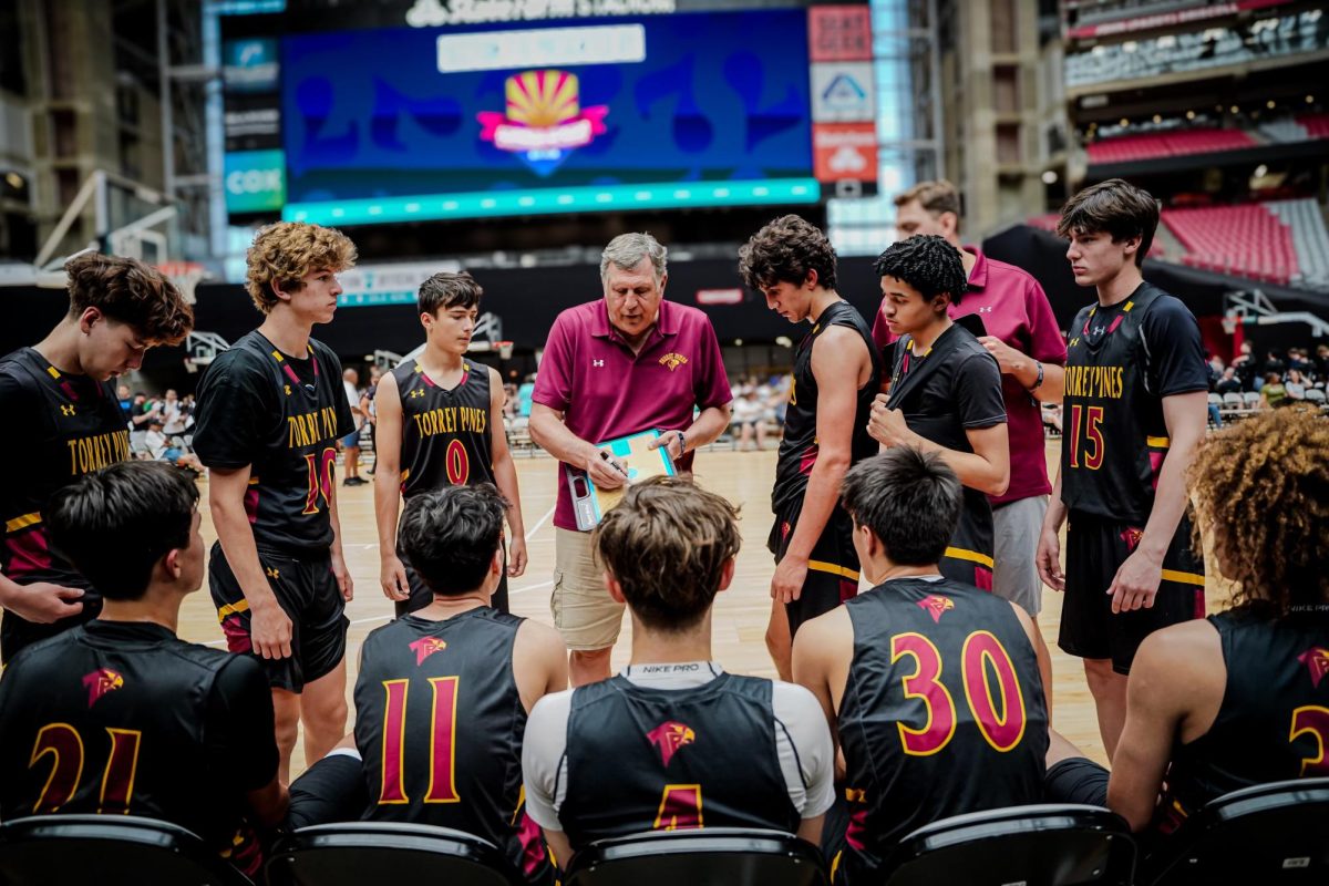 The boys varsity basketball team huddles around Coach Olive. The team participated in the Section 7 tournament in Phoenix, Ariz. over the summer. 
Photo courtesy of Zain Mehio