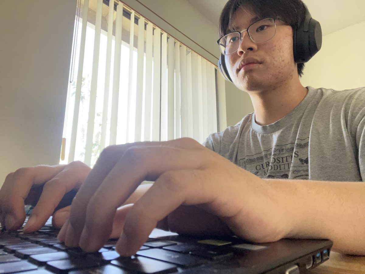 Eric Lee, Assistant Editor-in-Chief of Design, types away at the computer in his room. In one word, Lee described himself as neurotic in his personal perspective. 