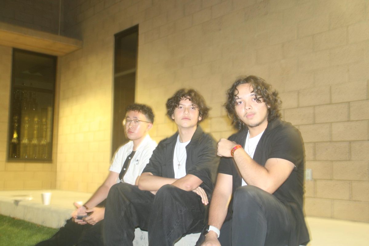 Left to right: Kingston Liu (12), Jacob Limon (12) and Santiago Herrero (12) relax at the top level of the amphitheater. This was one of many places students could relax and hang out at the dance. 