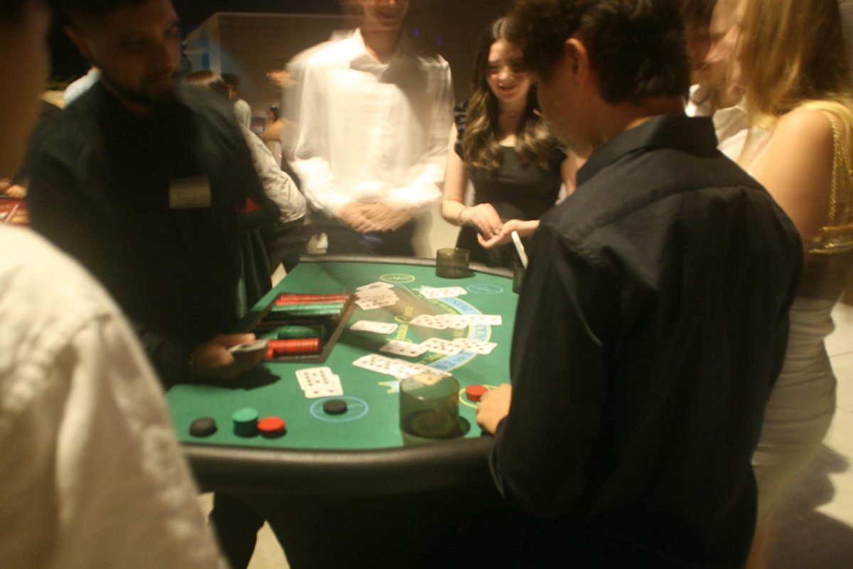 Students play a variety of casino games such as blackjack and roulette. This was one of many activities for students to participate in outside of the dance. 