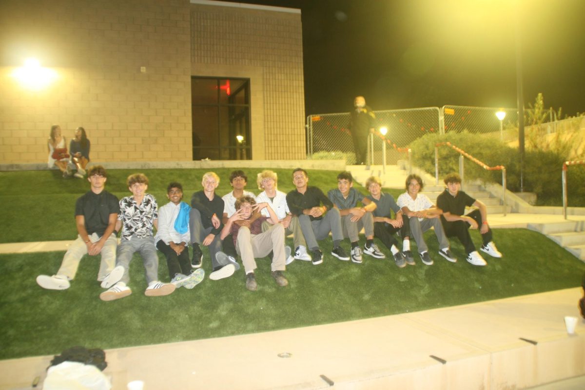 A group of students line up on the grass hill of the amphitheater. The dance took place inside the amphitheater.