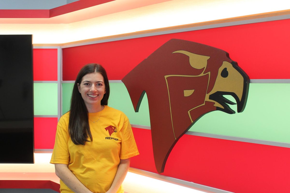 Adviser Kara Adler smiles in the new Falcon Vision studio, where they host live broadcasts every Friday. Last year, Adler taught Video Film I, TV Production and Advanced Video Film.