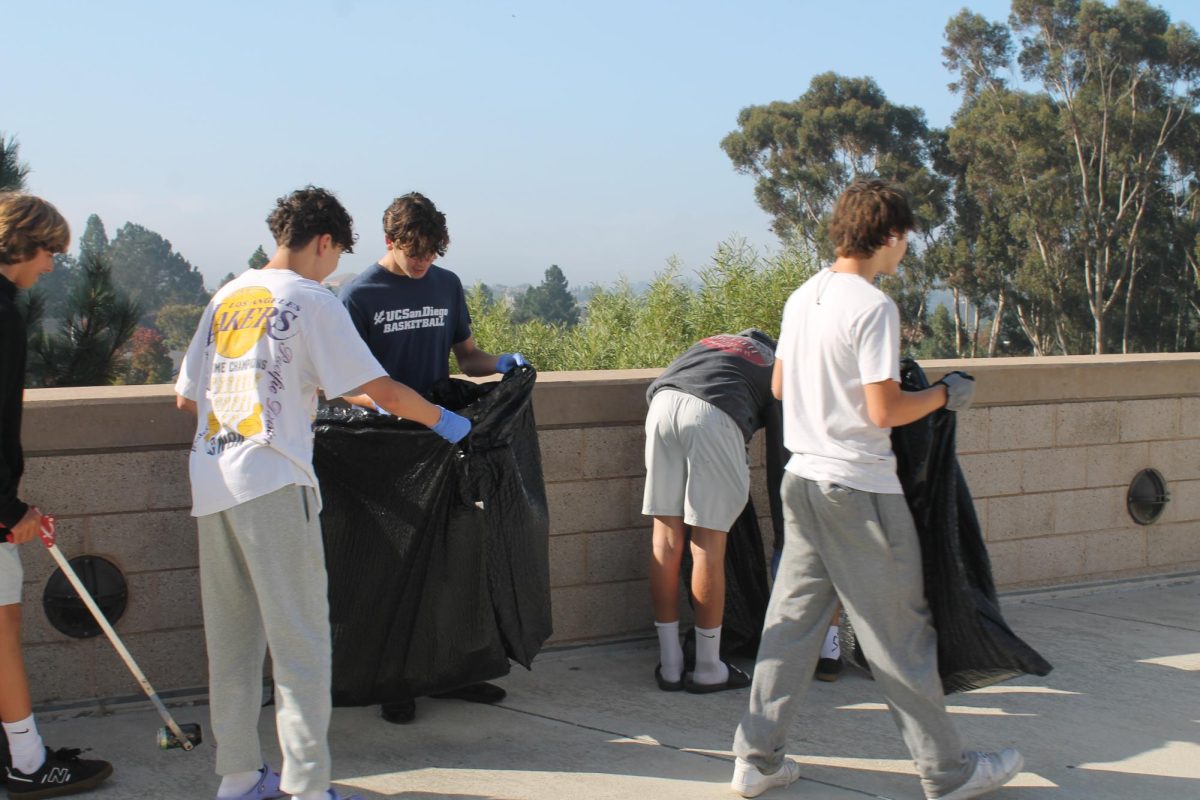 Student volunteers collect trash around the English building. The event was promoted through the TPHS Foundation and ASB.