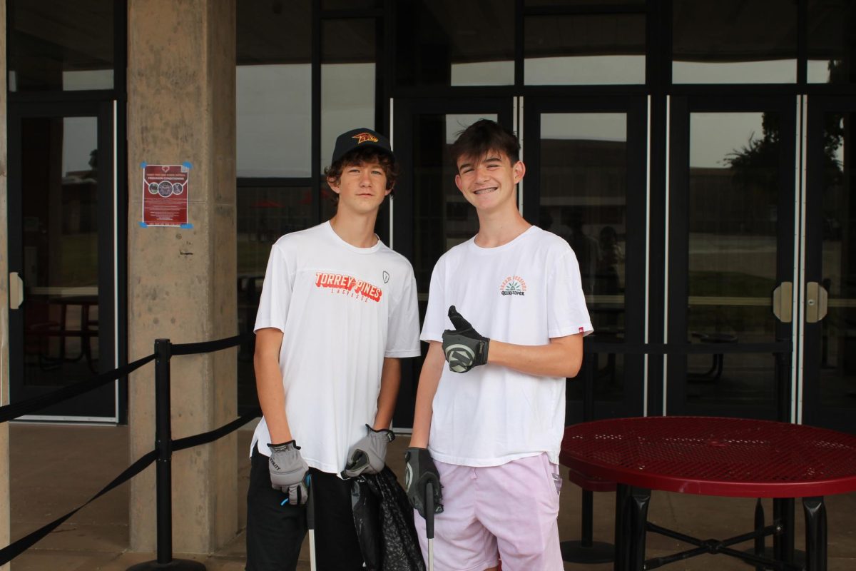 Student volunteers help pick up trash in front of the Falcon Eatery. Volunteers helped clean a variety of areas across campus. Left to right: Finnegan Gizzi (9) and Warren Loftsgard (10).