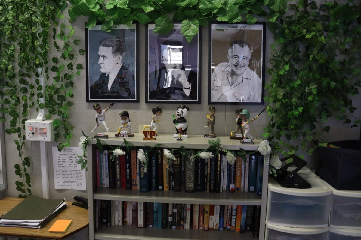 English 10 Honors, English 11 and Yearbook teacher Brandon Keller has photos of writers, framed by artificial greenery. Keller drew inspiration from a previous professor. "I saw that and wanted to mimic it in my classroom."