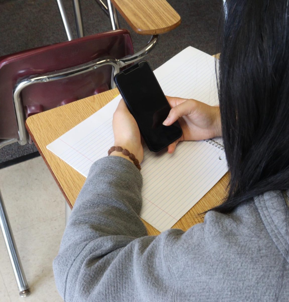 A student goes on their smartphone instead of working on schoolwork. Governor Gavin Newsom signed the Phone-Free Schools Act on Sept. 23, which requires all California school districts to create and adopt a policy that limits or prohibits smartphone use.