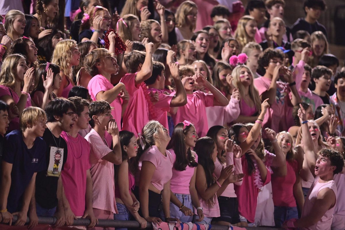 The schools student section, Cardinal Chaos, is only allowed to use a slim amount of props. Other school districts in the area have permitted their student sections to use more enticing props like fireworks, powder and beachballs. Photo courtesy of Anna Scipione.