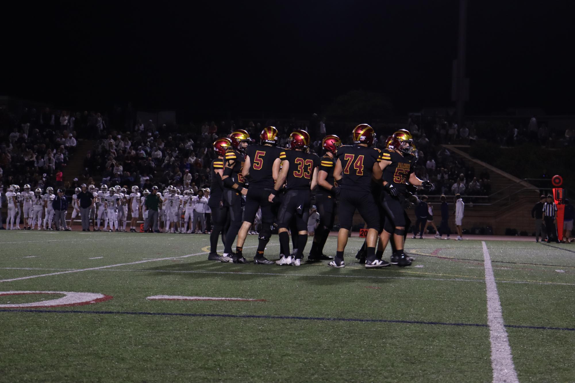 The varsity football team (4-6) lines up for a play against La Costa Canyon High School (10-0). The Falcons fell to their long standing rivals, the Mavericks, on Friday night with a final score of 28-0. 