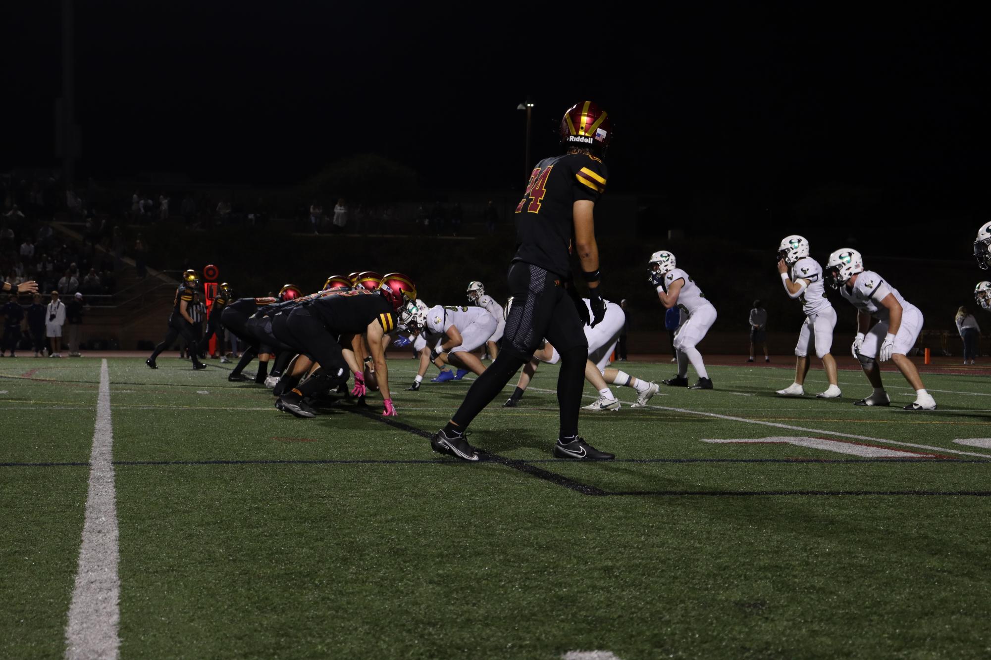 The varsity football team (4-6) lines up for a play against La Costa Canyon High School (10-0). The Falcons fell to their long standing rivals, the Mavericks, on Friday night with a final score of 28-0. 