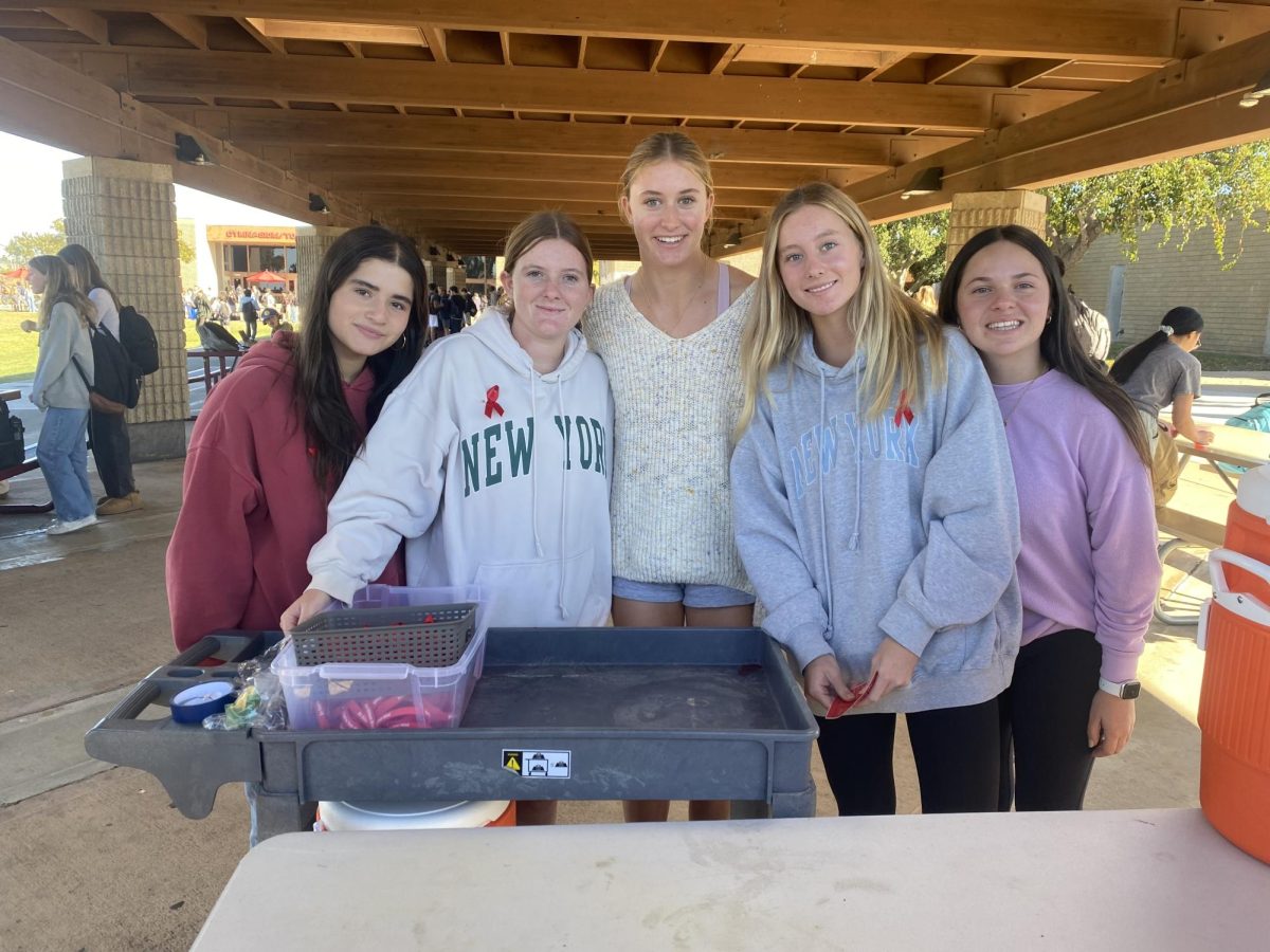 PALs members smile by the Kool-Aid booth. Other events included passing out red pins and candy, as well as a drunk goggle simulation. Left to right: Shyla Mighdoll (12), Ryann Holohan (10), Greta Pennock (10), Aubrie Dingman (10) and Gaby Shanner (10).