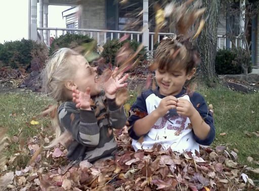 Cash Weaver ('24) and Liv Weaver (12) enjoy playing in fall leaves outside their former Chicago home. The two moved with their parents to California shortly after. Photo courtesy of Liv Weaver. 