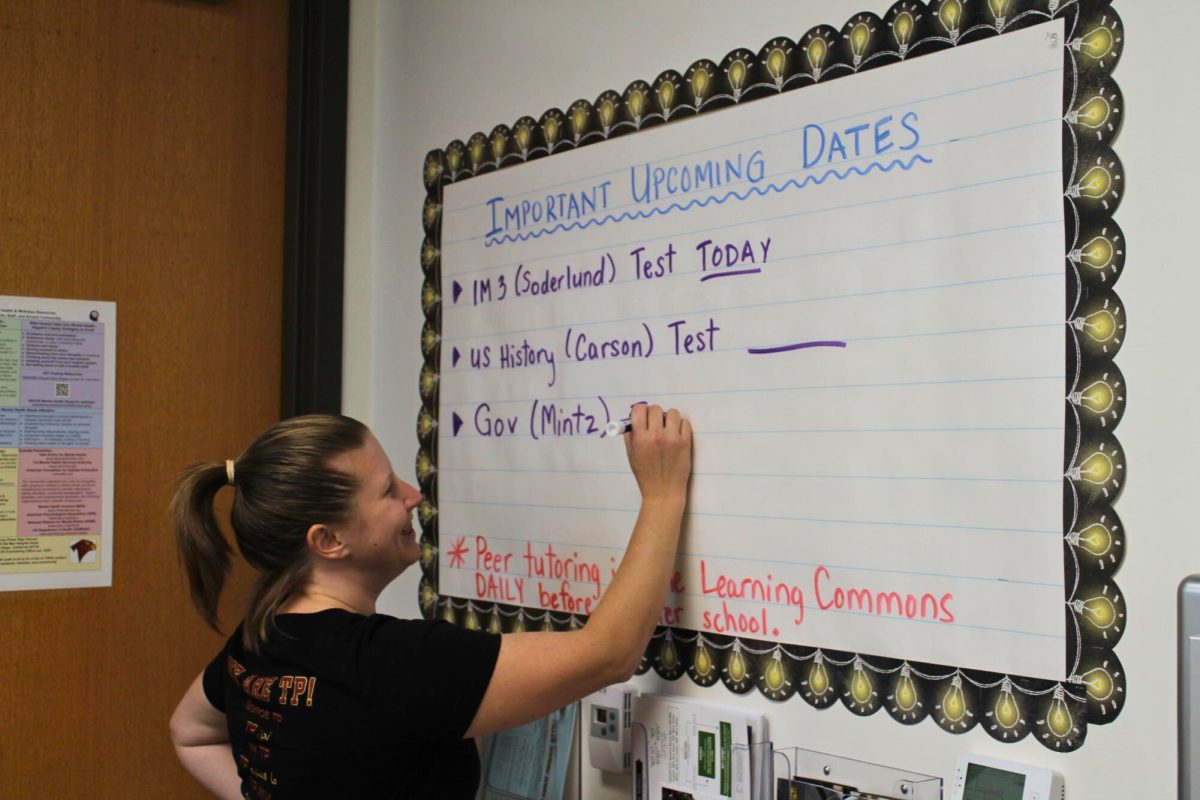 Jennifer Boranian writes upcoming dates for her students on a classroom board. This year, Boranian stepped into the role of education specialist at the school.