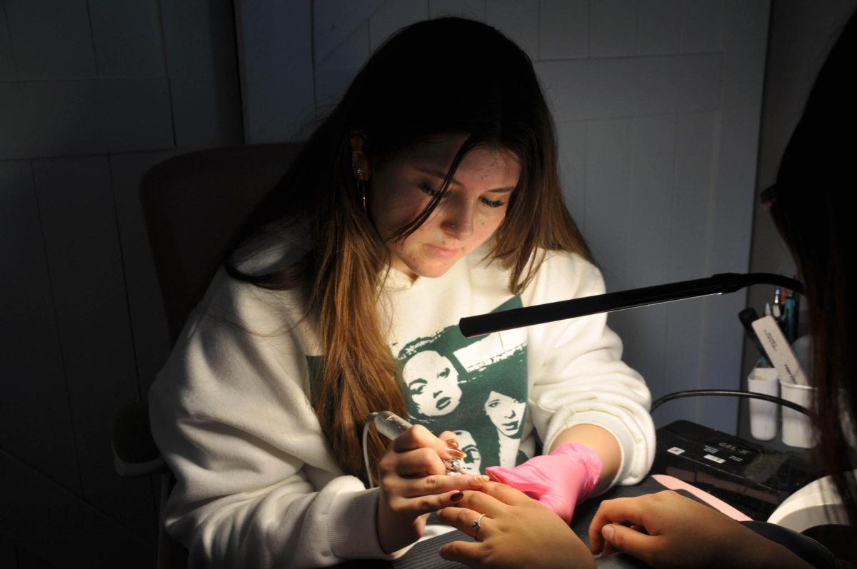 Student nail technician Myah Gutierrez (10) works on a client's nails. Gutierrez started her nail business, NailzByMyah, last November. Photo courtesy of Lauren Walker. 