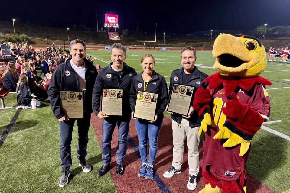 From left to right: Taylor Steele (‘90), Eric Hirshberg (‘86), Rachel Buechler (‘03) and Dan McGuire (‘84) are inducted into the school's Hall of Fame. The ceremony was held during halftime at the football game against Poway High School on Oct. 25. Photo courtesy of TPHS Foundation. 