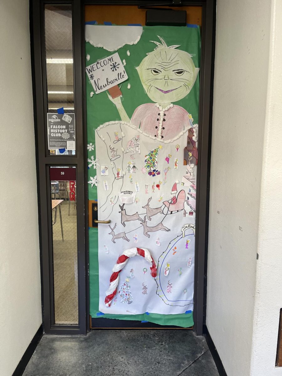 Julie Neubauer's door shows Grinch. The decoration includes drawings of reindeers, a candy cane and other holiday spirit.