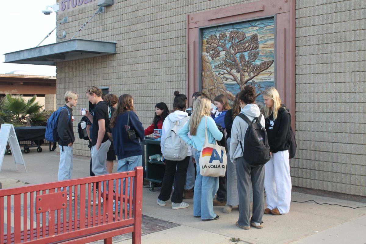 Students line up to receive hot chocolate from PALs Monday morning. PALs' Stress Less Week took place this week, marked by various activities each day.