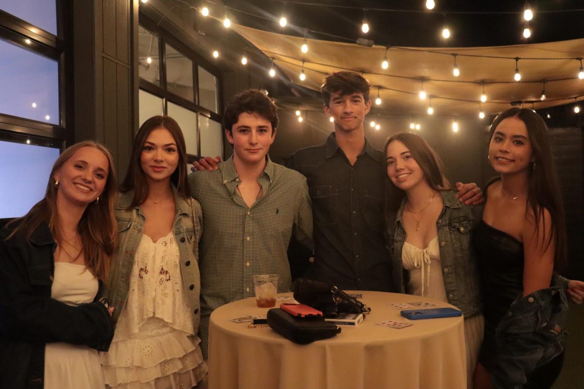 Students smile for a picture. The venue also offered playing cards. Left to right: Gwendolyn Bezdek (10), Amelia Mazo (10), Antonio Mazo (10), Eli Twitty (10), Kiva Saitowitz (10) and Brooke Thomas (10).