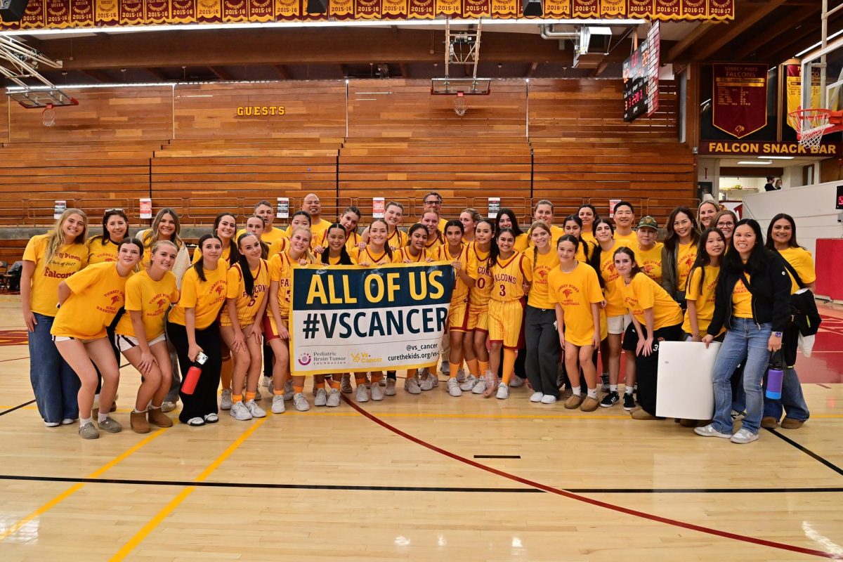 The girls varsity basketball team (12-5) gathers in yellow, showing support for childhood cancer. The team raised $3,663 through their fundraiser during a game against Canyon Crest Academy on Jan. 10. Photo courtesy of Anna Scipione.