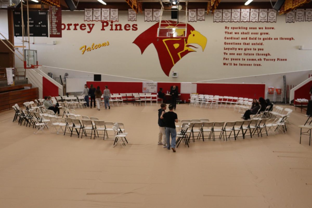 Arriving students make their way to their seats. The chairs were aligned in a circle, where various events took place.