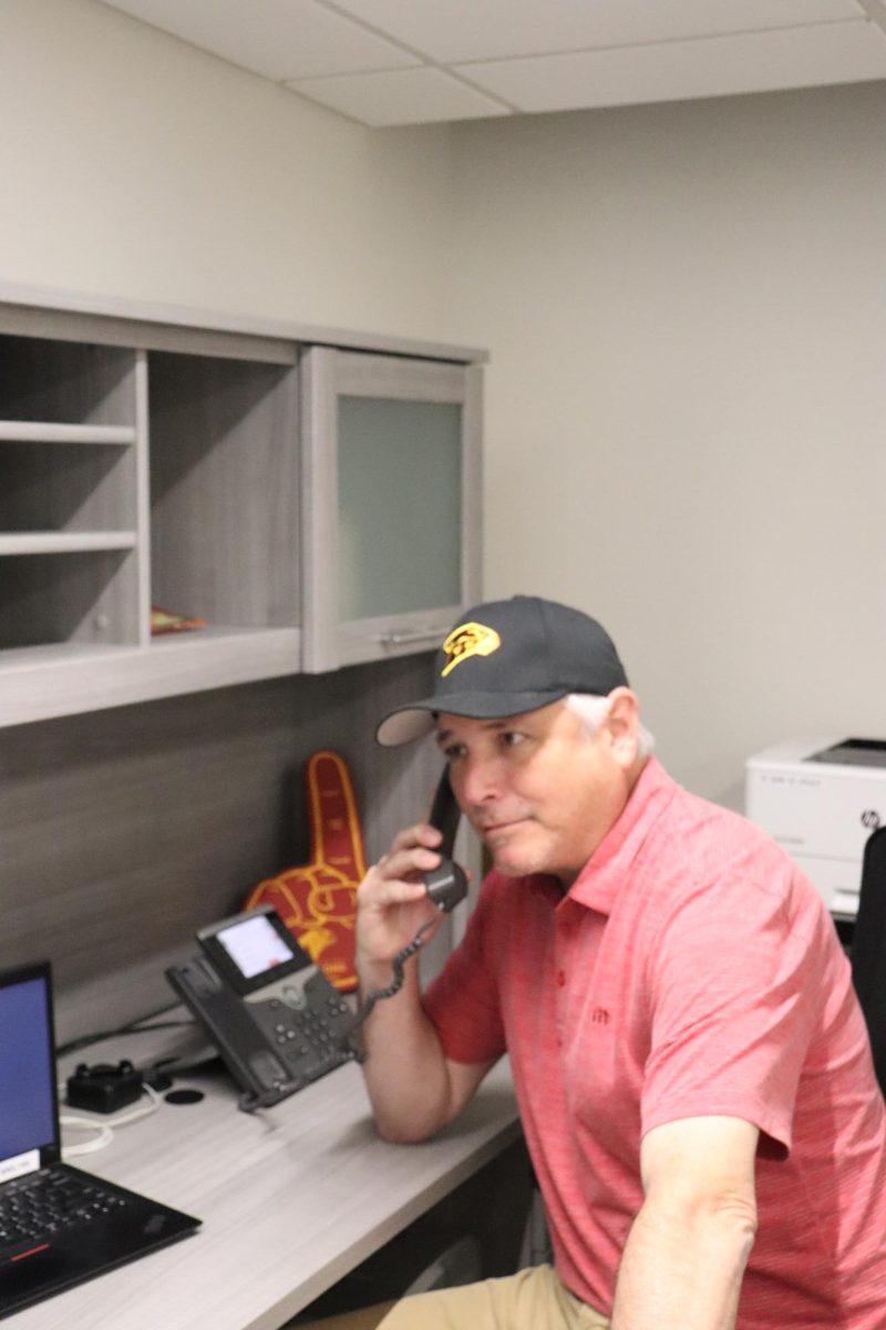 Nathan Molina poses with the telephone. Molina has been in education for _ years, from Los Angeles to Carmel Valley Middle School.