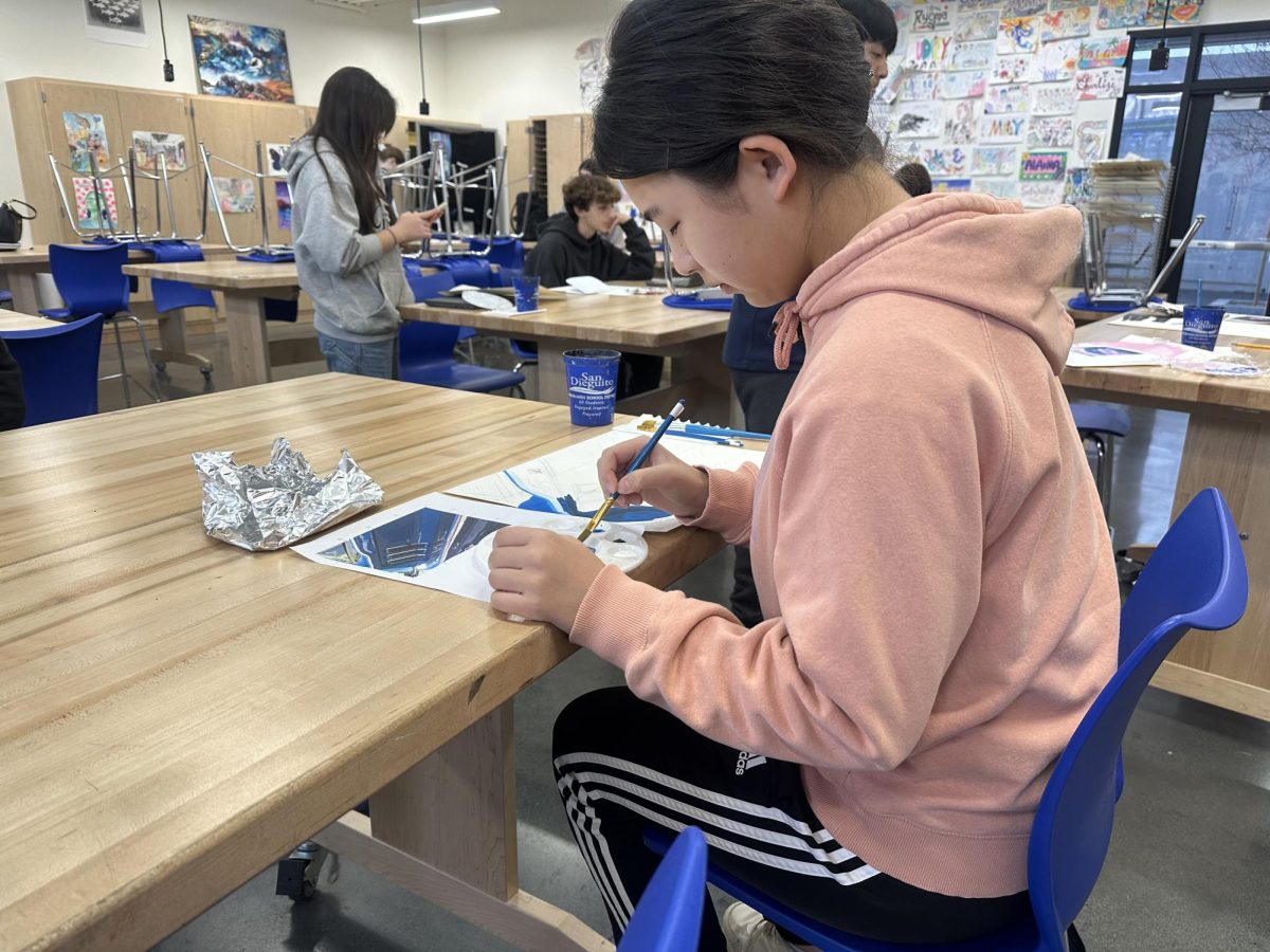 Sawako Ogino paints away during her first period class. Ogino was recently named the January Artist of the Month.