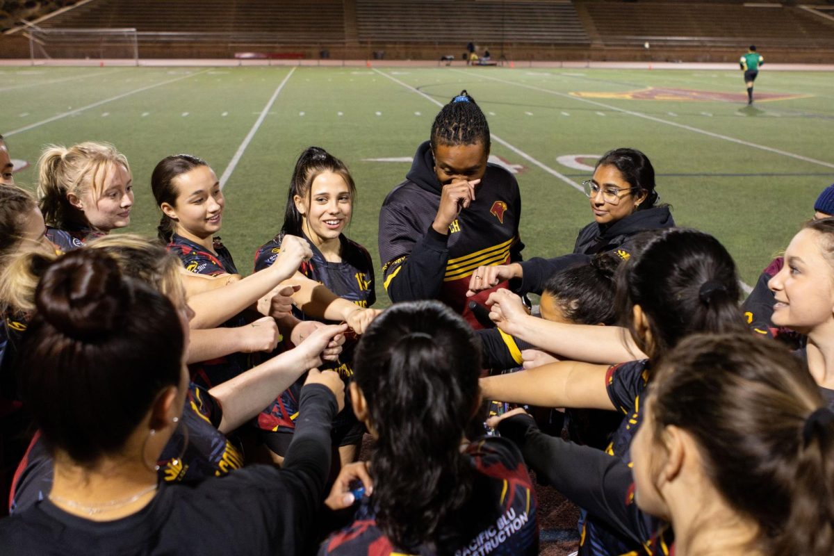 All hands in as the Girls Falcons Rugby team (12-5) does their cheer before kickoff. The team only lost five games this season, making them a strong competitor in the San Diego area. Photo courtesy of Elijah Seay.