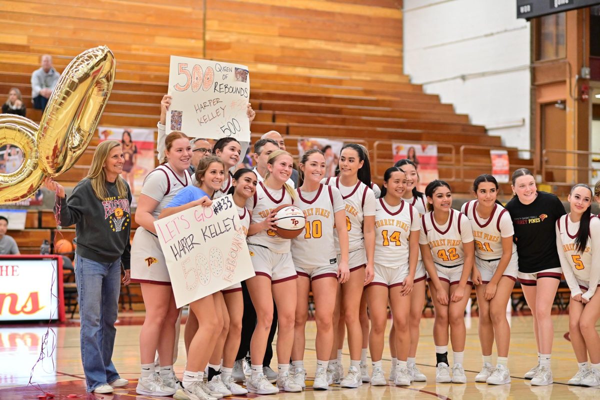 The girls varsity basketball team (18-7) celebrates with Harper Kelly (12). The team beat Sage Creek (6-17) at home after a score of 69-21. Photo courtesy of Anna Scipione.