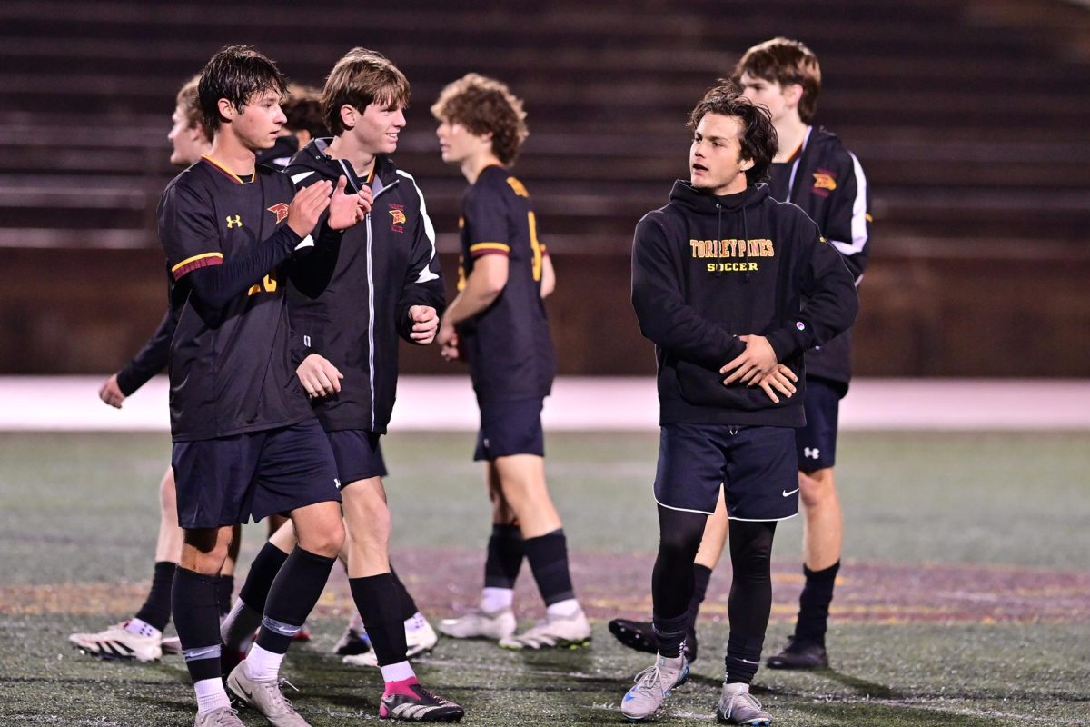 February Athlete of the Month, Jack Bottini (12), applauds his fans after a game. This was Bottini's second year being crowned as Athlete of the Month. Photo courtesy of Anna Scipione. 