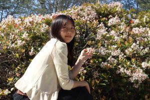 April Kato (12) crouches near a bush of flowers. In her personal perspective, Kato reflected on the experience living between two worlds — Japan and the United States, which came to construct her identity.