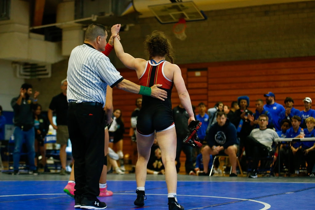 Ruby Julien-Newsom (12), March female Athlete of the Month, stands triumphant as the referee presents her as the winner. At the CIF State Championship on Feb. 6, Julien-Newsom was ranked the No. 2 wrestler in the state and No. 22 in the country. Photo courtesy of Ruby Julien-Newsom. 