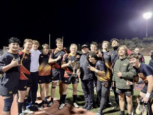 Falcons Rugby holds the SoCal Championship trophy after a well deserved win. The Falcons defeated Loyola High School Saturday night, resulting in a final score of 41-12. Left to right: Shay Farkash (11), Samuel Violett (12), Bryce Simon (12), Carson Palmberg (12), Will S (12), James Curtis (12), Matty Sandoval, Gabe Gonzalez (11) Will Barrett (12), Jacob Herman (12), Sadha Nagaram (12), Gunnar Paul (12) and Finn Johnson (11). Photo courtesy of James Curtis. 