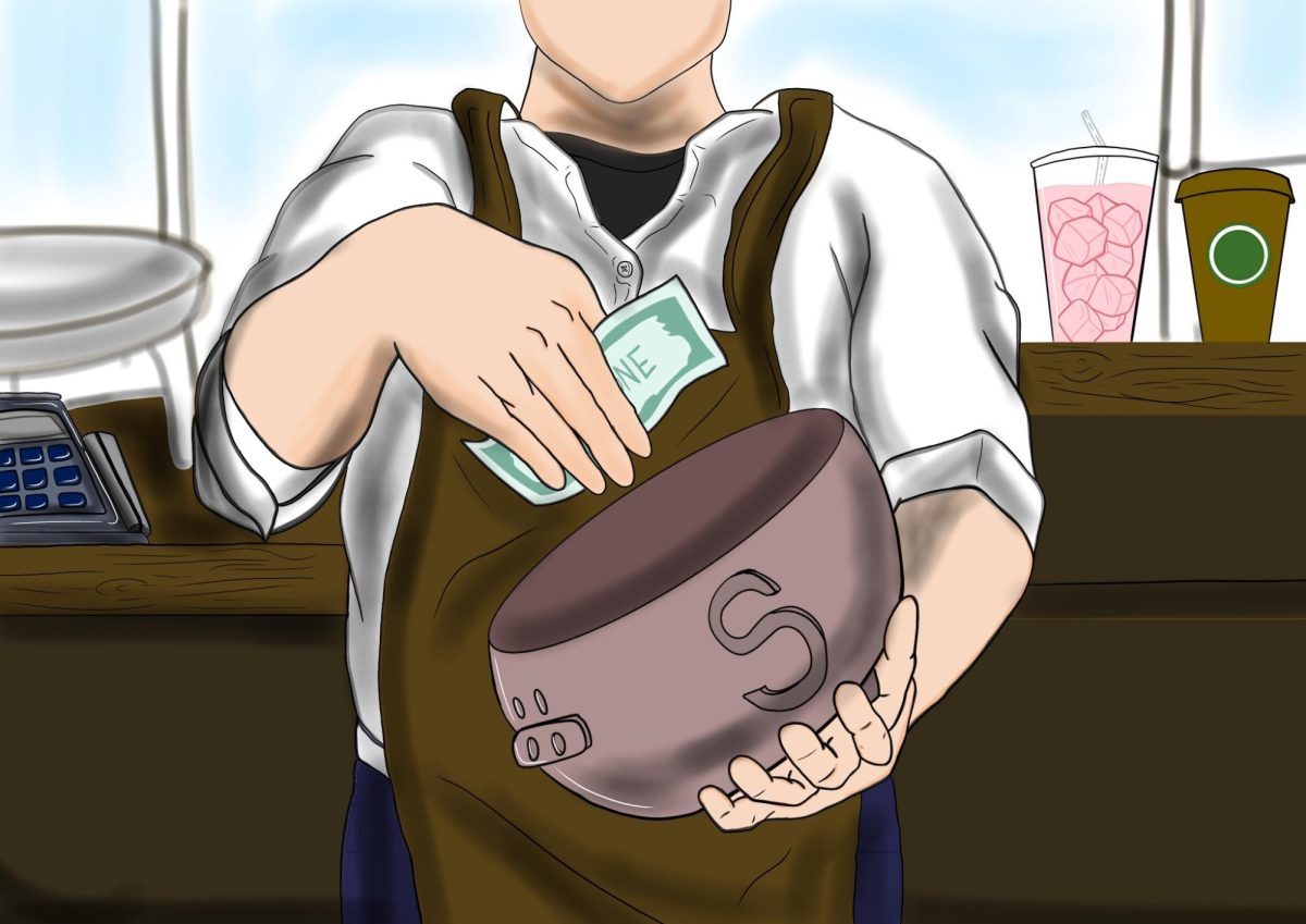 A student is behind the counter, working a shift after the bell rings. Having a high school job contributed greatly to their money-managing skills and their understanding of hard work.