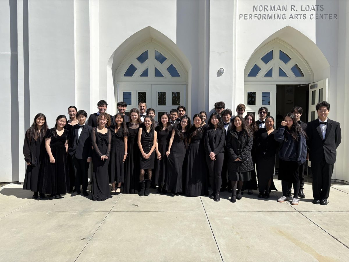 TP Chamber Strings gathers in front of the Norman R. Loats Performing Arts Center. They received the unanimous superior performance rating at the festival, qualifying for regionals. Photo courtesy of Thomas Ducom.