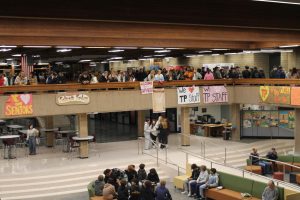 A crowd of incoming freshmen and families fill up the B Building. Freshman Welcome Night started with a presentation from the principal and others, ending with the new student group exploring the programs' display area.