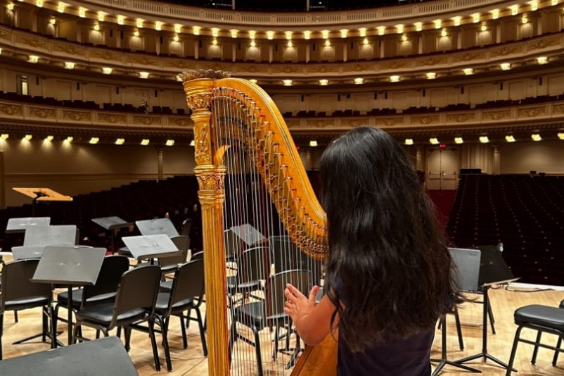 April Artist of the Month, Emma Valdez (10), plays her harp on stage. Valdez started playing the harp 10 years ago, and was fueled by the vibrant passion in her household. Photo courtesy of Emma Valdez.
