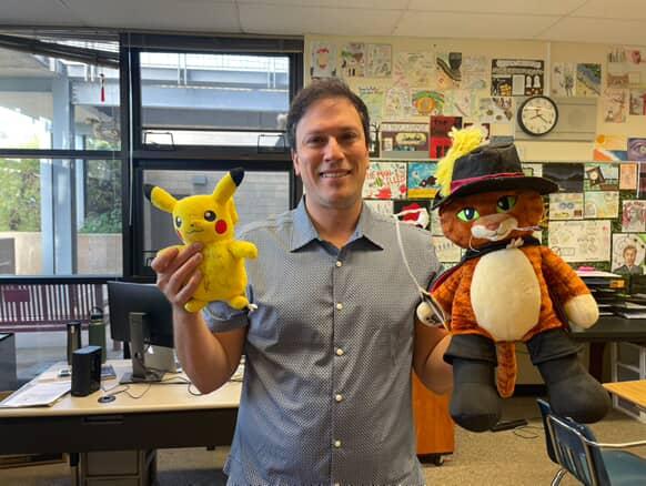 English 10, English 11 and Yearbook teacher Brandon Keller poses for a photo with gifts from past students. Staff Appreciation Week was held this year from May 5 to 9.