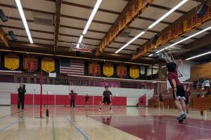 Members of the badminton team play against another team. The team has been expressing the need for permanent court lines to be painted in the school gym. Photo courtesy of TPHS Badminton Instagram.