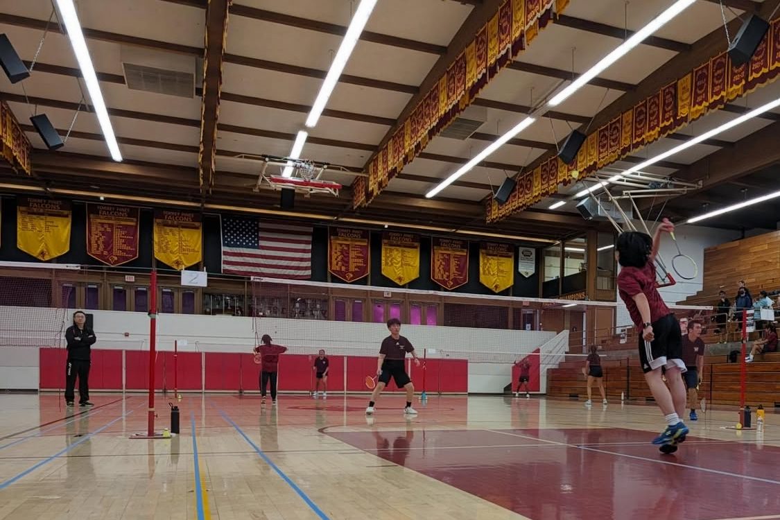 Members of the badminton team plays against another team. The team has been expressing the need for permanent court lines to be painted in the school gym. Photo courtesy of TPHS Badminton Instagram.