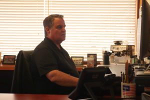 Principal Rob Coppo works at the computer in his office and handles administrative tasks. In addition to his duties as principal, Coppo began hosting a podcast with former teacher Don  Collins in 2023. 