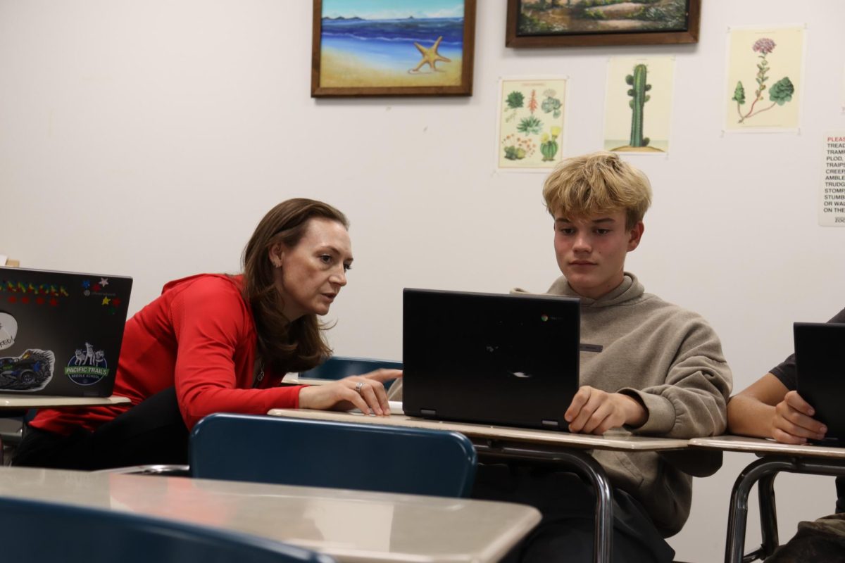 Krommenhoek sits with Bradley Pierce (9) and walks him through his homework. She joined the school this year after spending the last ten years at Pacific Trails Middle School 