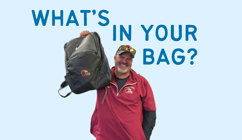 Varsity football head coach Scott Ashby holds up his football backpack. He received this bag six years ago. 