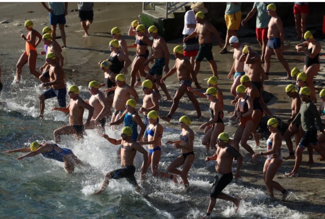 Swimmers dive in the cove to begin the three-mile race. Nine-hundred participants kicked off the 107th annual La Jolla Cove Open water swim on Sunday, Sept. 7. Photo courtesy of Ava Fergerson.