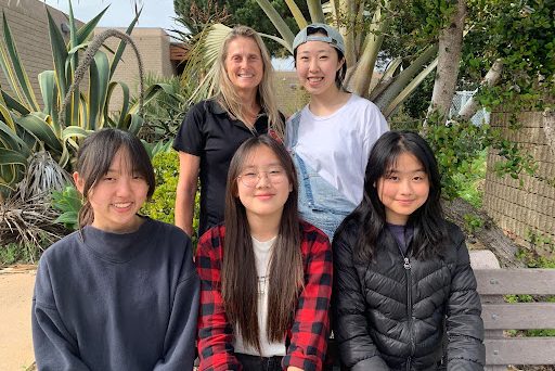 The Falconeers, Jiwon Ryu (12) (top, right), Yewon Jeong (10) (bottom, left), Jaehee Nam (10) (bottom, middle) and Zhixin Chen (11) (bottom, right), smile for a picture with their mentor Julianna Newell (top, left). The group designed a product for Sustainable Goal Development 15: Life on Land. Photo courtesy of Sarah Tsu. 