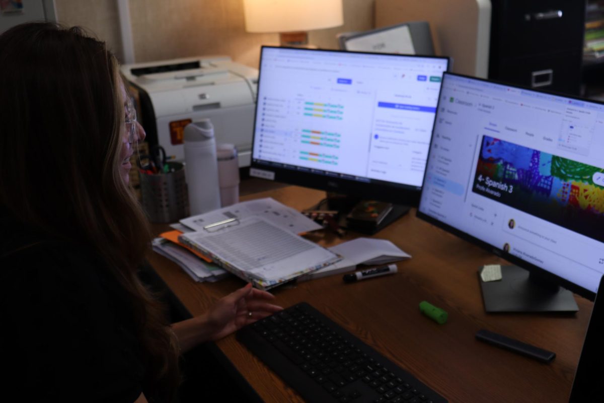 Spanish teacher Viviana Alvarado-Gomez works on grading her students' tests. Alvarado-Gomez spoke about the importance of Spanish classes for native speakers.