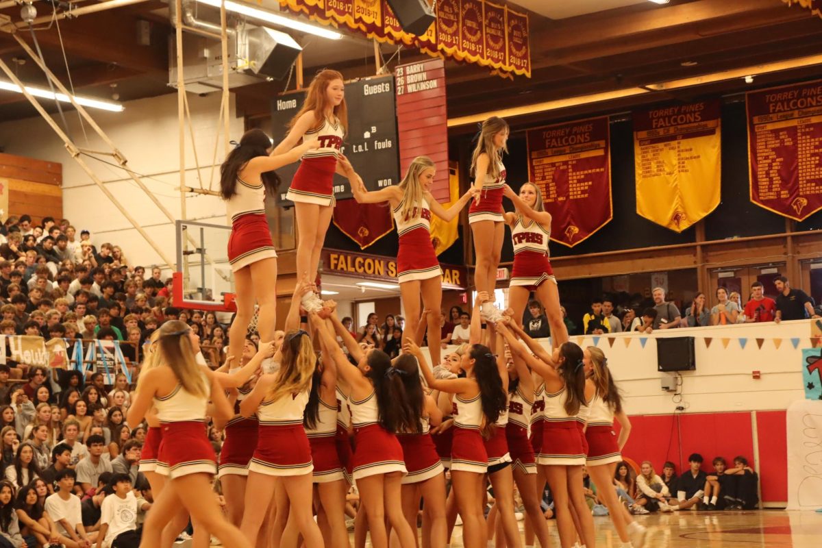 Top left to right: Haley Rubin (12), Alyxandria Douglas (9), Saige Aiken (11), Clare Donnelley (12) and Haley Diorio (11). The cheer team executes their routine during the pep rally. They performed their signature cheer and showcased their stunts.