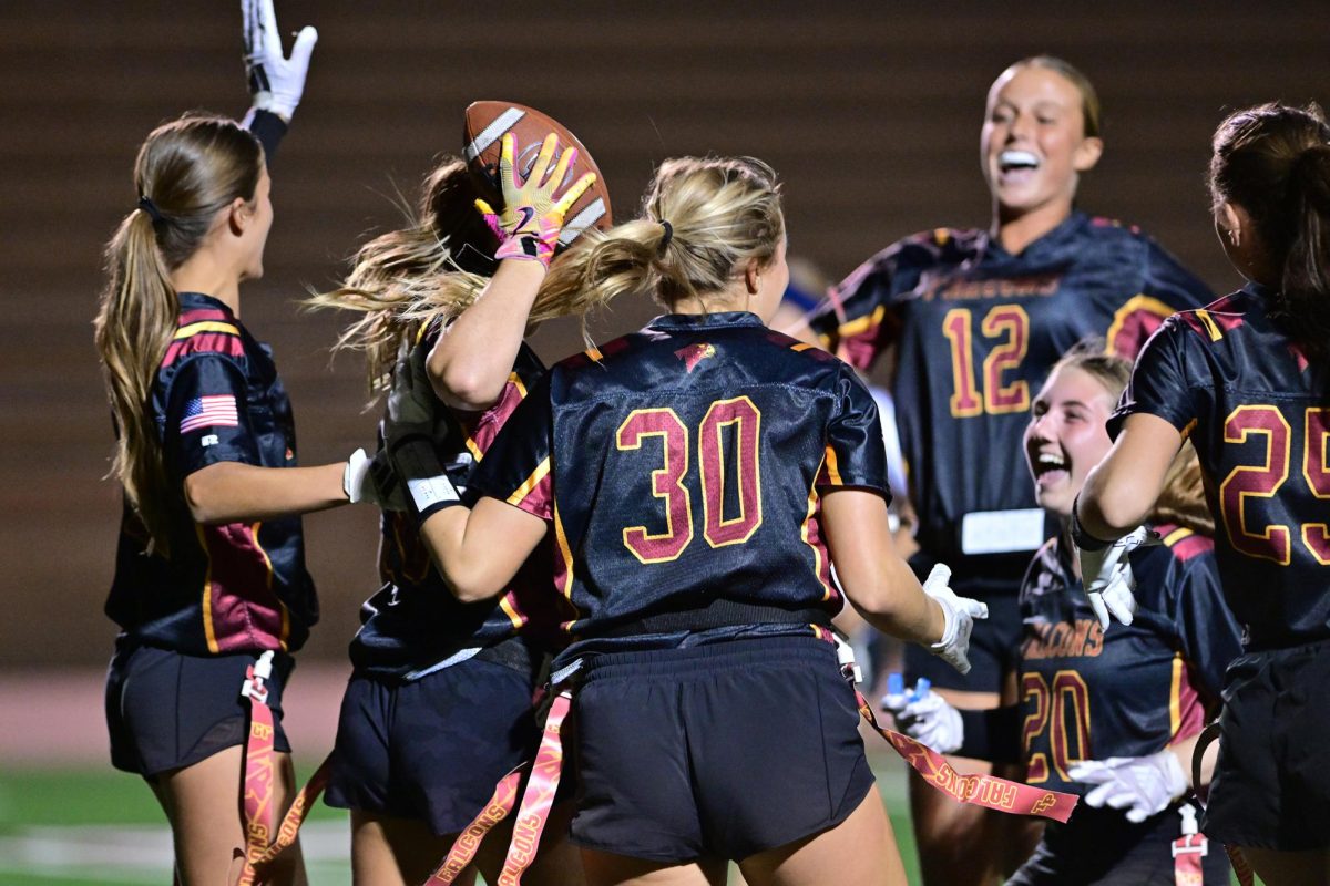 Varsity flag football players cheer after a successful play. The players celebrated Senior Night on Oct. 6. Photo courtesy of Anna Scipione.