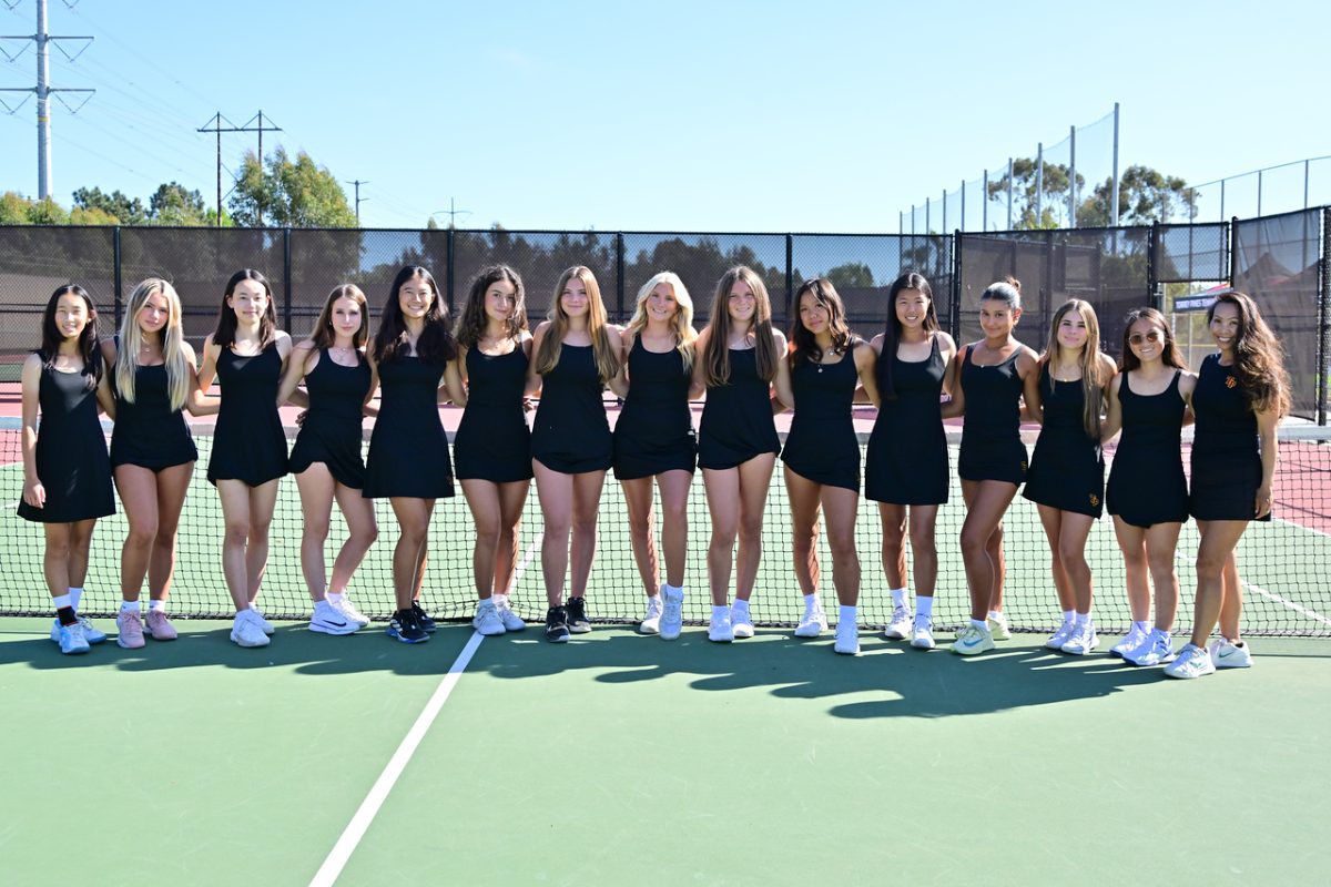 (Left to right:) Annabelle Liao (9), Maria Gutierrez Prieto (11), Elle Eisenbeis (12), Chloe Kappes  (10), Lulu Li (9), Giuliana Ponomarev (10), Ruby Resch (11), Ella Burchell (12), Jordan Stack (10), Sophie Yang (9), Sophia Yu (9), Tessa Koff (10), Coco Wehrli (11), Angie Sun (11) and varsity head coach Jan Guevara smile arm-in-arm for a team photo. They won 11-7 against Rancho Bernardo High School last Tuesday. Photo courtesy of Anna Scipione.