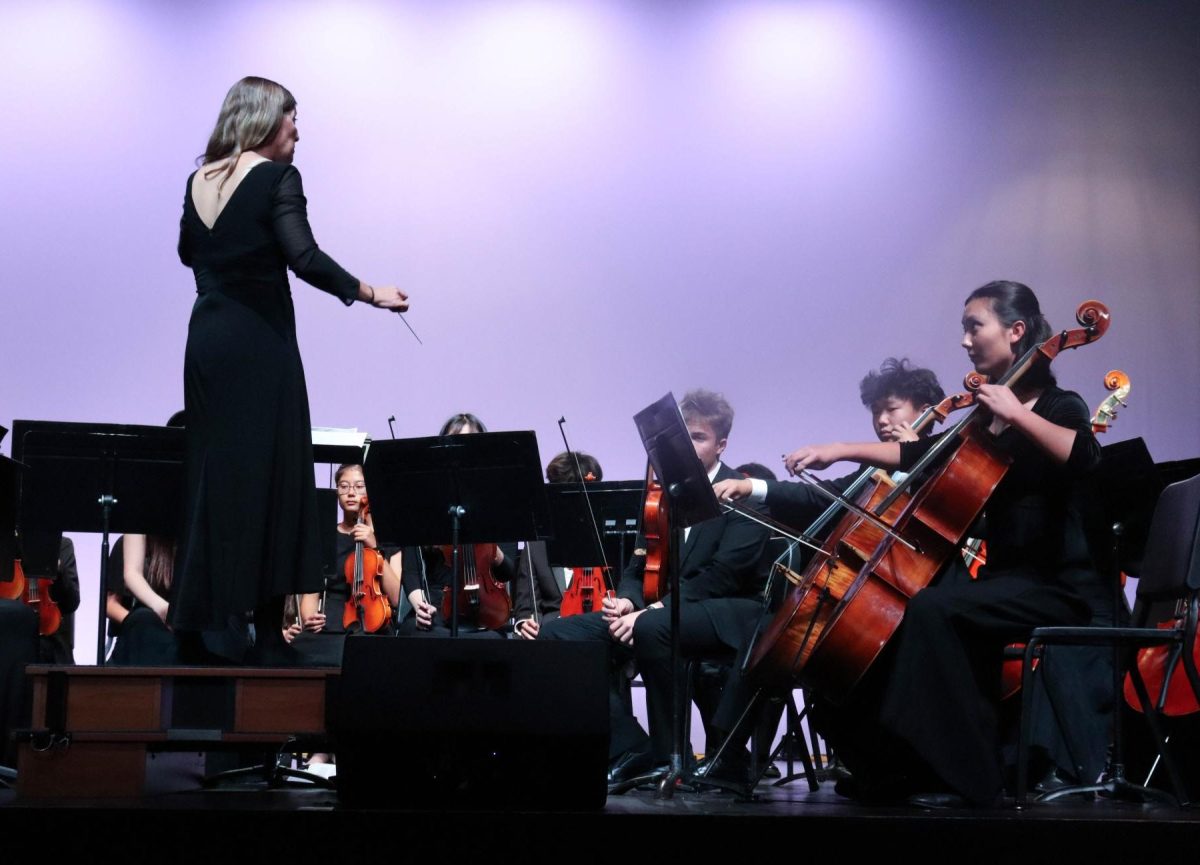 Conductor Amy Gelb (left) begins "Fantasy on Amazing Grace" by turning to the first chair Vera Muller (10) (right). The piece swept through Baroque, Classical, Romantic and early 20th century period styles.