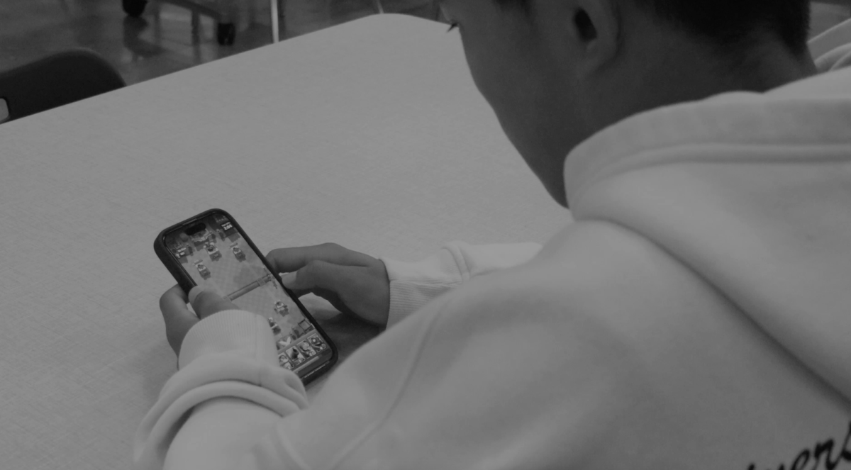 A student sits playing a game on his phone. This PSA was created to show the importance of limiting time on your smartphone. Photo courtesy of Jacob Taylor. 