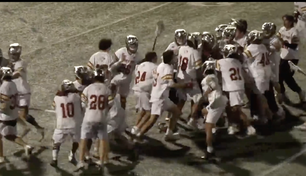 The school's lacrosse team celebrates after a game. The team worked to give back off the field as well. Photo courtesy of Max Brown. 